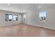 Bright and airy living room with hardwood floors and multiple windows at 13502 E 100Th Ave, Commerce City, CO 80022