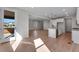 Open floor plan connecting the kitchen and living areas with hardwood floors at 13502 E 100Th Ave, Commerce City, CO 80022