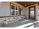 Covered patio with stonework and view of backyard at 13502 E 100Th Ave, Commerce City, CO 80022