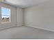Simple bedroom with carpet and a window overlooking the neighborhood at 13502 E 100Th Ave, Commerce City, CO 80022