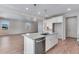 Modern kitchen with white cabinets, stainless steel appliances and a large island at 13502 E 100Th Ave, Commerce City, CO 80022