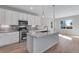 Modern kitchen featuring white cabinets, stainless steel appliances, and quartz countertops at 13502 E 100Th Ave, Commerce City, CO 80022