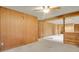 Spacious basement rec room with wood paneling and carpeted floor at 1760 S Uinta Way, Denver, CO 80231