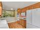 Mid-century kitchen with wood cabinets, white appliances, and a mural at 1760 S Uinta Way, Denver, CO 80231