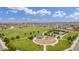 Aerial view of a community park with playground, tennis courts and open green space at 16395 Milwaukee St, Thornton, CO 80602