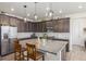 Spacious kitchen with an island, stainless steel appliances, and dark cabinets at 16395 Milwaukee St, Thornton, CO 80602