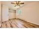 Bright bedroom with ceiling fan, closet, and wood-look floors at 585 S Alton Way # 2C, Denver, CO 80247