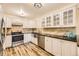 Modern kitchen with white cabinets, granite counters, and stainless steel appliances at 585 S Alton Way # 2C, Denver, CO 80247