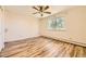 Bright bedroom with wood-look floors and a large window at 585 S Alton Way # 2C, Denver, CO 80247