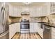 Updated kitchen with stainless steel appliances and white cabinets at 585 S Alton Way # 2C, Denver, CO 80247