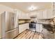 Stainless steel appliances and white cabinetry in this updated kitchen at 585 S Alton Way # 2C, Denver, CO 80247