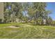 Landscaped lawn with mature trees in front of building at 585 S Alton Way # 2C, Denver, CO 80247