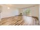 Bright living room with wood-look floors and sliding glass door to balcony at 585 S Alton Way # 2C, Denver, CO 80247