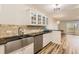 Modern kitchen features white cabinets, granite counters and stainless steel appliances at 585 S Alton Way # 2C, Denver, CO 80247