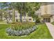 Building entrance with landscaped flower bed at 585 S Alton Way # 2C, Denver, CO 80247