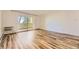 Living room with hardwood floors and sliding door to balcony at 585 S Alton Way # 2C, Denver, CO 80247
