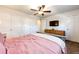 Main bedroom with ceiling fan, ample closet space, and TV at 693 S Flamingo Ct, Denver, CO 80246