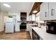 Updated kitchen with white cabinets, stainless steel appliances and wood accents at 693 S Flamingo Ct, Denver, CO 80246