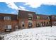 Attractive two-story brick home with a partially snow-covered front yard at 5747 S Lowell Blvd, Littleton, CO 80123