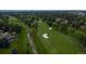 Aerial view of a lush golf course with a small creek, trees, and residential homes at 5747 S Lowell Blvd, Littleton, CO 80123