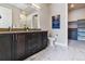 Bathroom with double vanity, marble tile, and walk-in shower at 20 Wilcox St # 621, Castle Rock, CO 80104