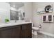 Modern bathroom with dark brown vanity, white toilet, and tiled shower at 20 Wilcox St # 621, Castle Rock, CO 80104