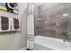 Clean bathroom with a shower/tub combo and gray tiled walls at 20 Wilcox St # 621, Castle Rock, CO 80104