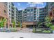 Elegant building entrance with landscaping and seating area at 20 Wilcox St # 621, Castle Rock, CO 80104