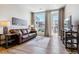 Living room with leather sofa, large window, and balcony access at 20 Wilcox St # 621, Castle Rock, CO 80104