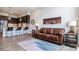 Living room with brown leather couch and city view at 20 Wilcox St # 621, Castle Rock, CO 80104