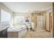 Bathroom with corner soaking tub and a separate walk-in shower at 5380 N Lariat Dr, Castle Rock, CO 80108