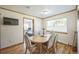 Bright dining area with wood table and chairs, offering views to a bedroom at 5380 N Lariat Dr, Castle Rock, CO 80108