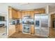 Modern kitchen with stainless steel appliances and oak cabinets at 5380 N Lariat Dr, Castle Rock, CO 80108