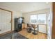 Small kitchenette with black refrigerator, microwave, and laundry at 5380 N Lariat Dr, Castle Rock, CO 80108