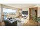 Living room with hardwood floors, fireplace, and stunning mountain views at 5380 N Lariat Dr, Castle Rock, CO 80108