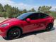 Red Tesla Model Y parked in the driveway at 5380 N Lariat Dr, Castle Rock, CO 80108