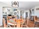 Rustic-style dining room with a round table and access to kitchen and Gathering room at 9508 E 147Th Ave, Brighton, CO 80602