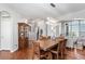 Dining room with hardwood floors, wooden table, and access to the kitchen at 9508 E 147Th Ave, Brighton, CO 80602