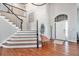 Elegant entryway with a curved staircase and hardwood floors at 9508 E 147Th Ave, Brighton, CO 80602