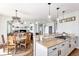 Kitchen with white cabinets, granite countertops, and island with gas cooktop at 9508 E 147Th Ave, Brighton, CO 80602