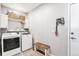 Bright laundry room, features washer, dryer, storage, and bench at 9508 E 147Th Ave, Brighton, CO 80602