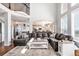 Spacious living room with a large sectional sofa and high ceilings at 9508 E 147Th Ave, Brighton, CO 80602