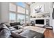 Open living room showcasing a cozy fireplace and ample natural light at 9508 E 147Th Ave, Brighton, CO 80602