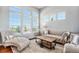 Living room with hardwood floors, chaise lounge, and large windows at 9508 E 147Th Ave, Brighton, CO 80602