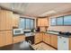 Well-equipped kitchenette featuring wood cabinets and modern appliances at 450 W Jefferson Ave, Englewood, CO 80110