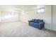 Bright, finished basement recreation area with large windows and a comfy couch at 13413 W 21St Ave, Golden, CO 80401