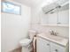 Small bathroom with toilet, sink, and vanity at 13413 W 21St Ave, Golden, CO 80401