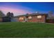 Brick ranch house with attached garage and well-manicured lawn at 13413 W 21St Ave, Golden, CO 80401
