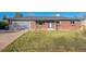 Front view of a ranch style home with a gray garage door at 13413 W 21St Ave, Golden, CO 80401