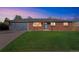 Brick ranch home with attached garage and well-maintained lawn at 13413 W 21St Ave, Golden, CO 80401